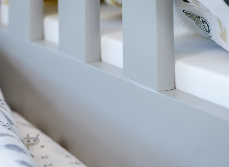 Precyzyjne wykończenie ramy łóżka przy materacu.