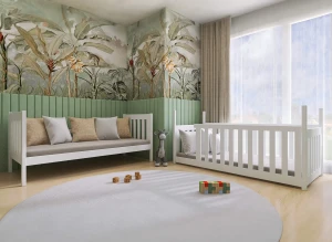 Biała drewniana sofa dziecięca i łóżeczko niemowlęce, w pokoju z tapetą w dżunglę i zielonymi panelami.